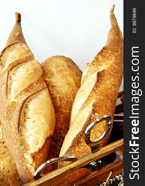 Bread in basket on wooden plate