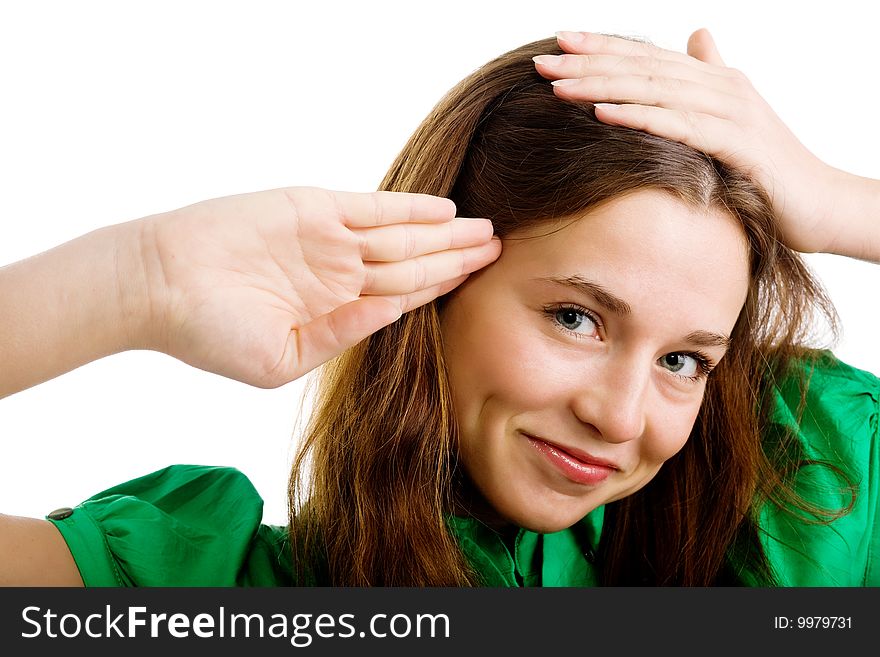 A pretty woman with hands at her head rendering a salute. A pretty woman with hands at her head rendering a salute