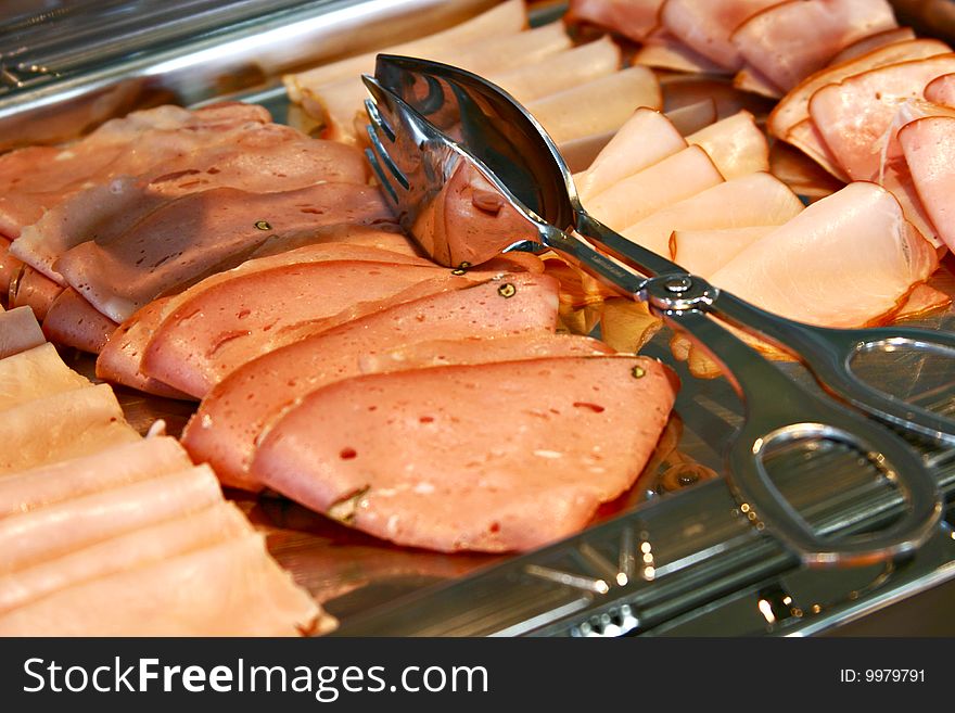 Salami for breakfast in shiny plate