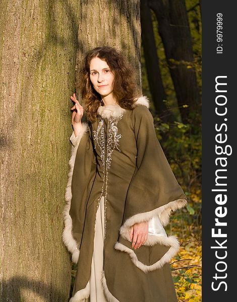 Lady in medieval brown dress in the forest. Lady in medieval brown dress in the forest