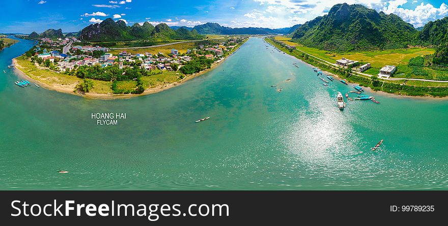 Aerial view of coastline along waterway on sunny day. Aerial view of coastline along waterway on sunny day.