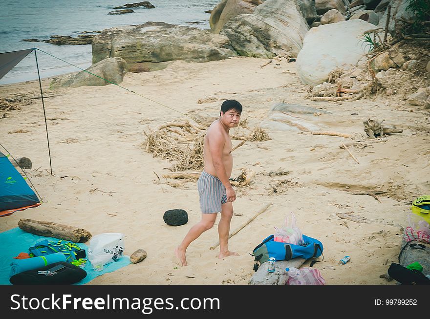 A boy near a camp on a beach. A boy near a camp on a beach.
