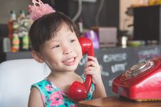 Girl Smiling While Talking With Her Friend By Red Classic Phone Stock Photo Girl Smiling While Talking With Her Friend By Red Classic Phone Stock Photo