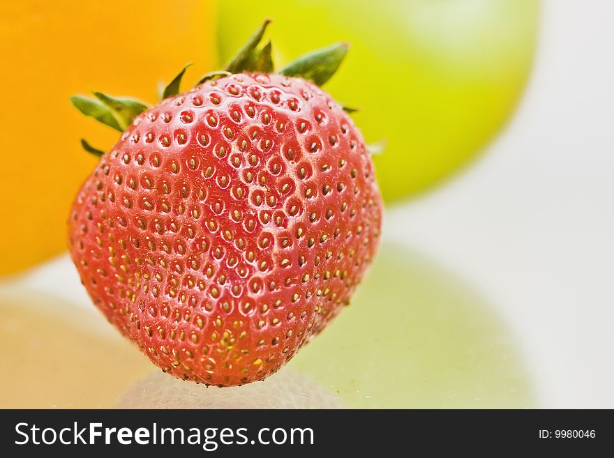 Delicious fresh fruit reflected on glass table