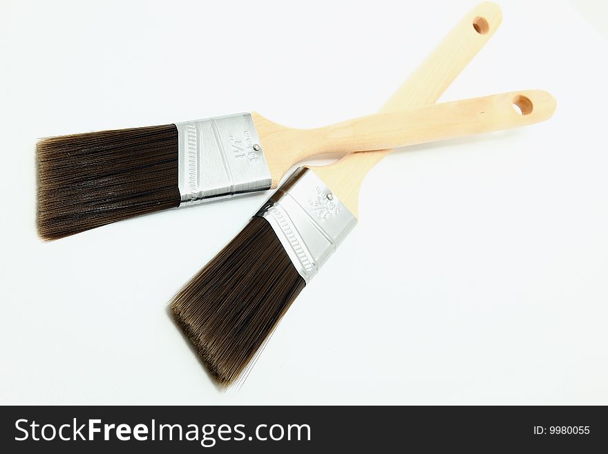 Two disposable paint brushes over white. Two disposable paint brushes over white.