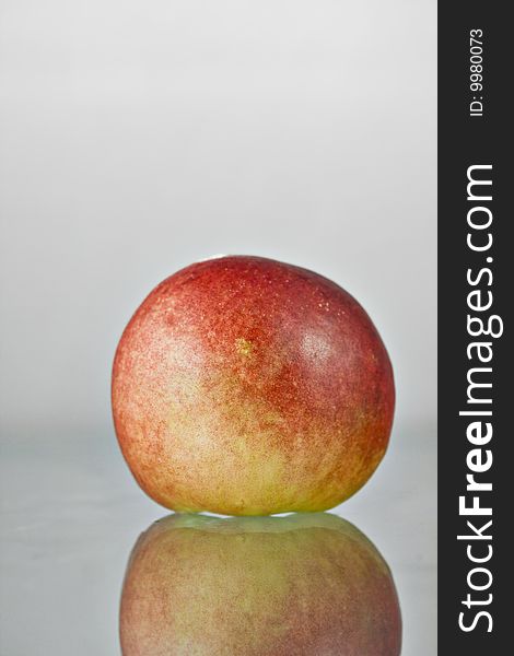 Close up shot of a red healthy peach with water drops against white background. Close up shot of a red healthy peach with water drops against white background