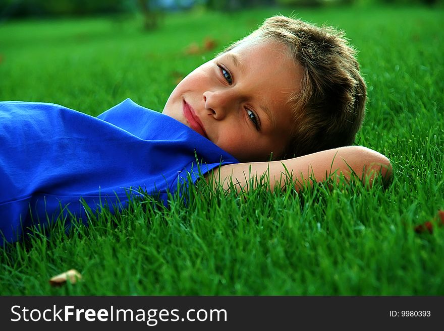 Boy laying on the grass