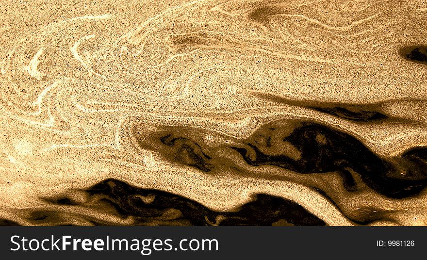 Macro shot of sand patterns created by rapidly swirling water. Macro shot of sand patterns created by rapidly swirling water