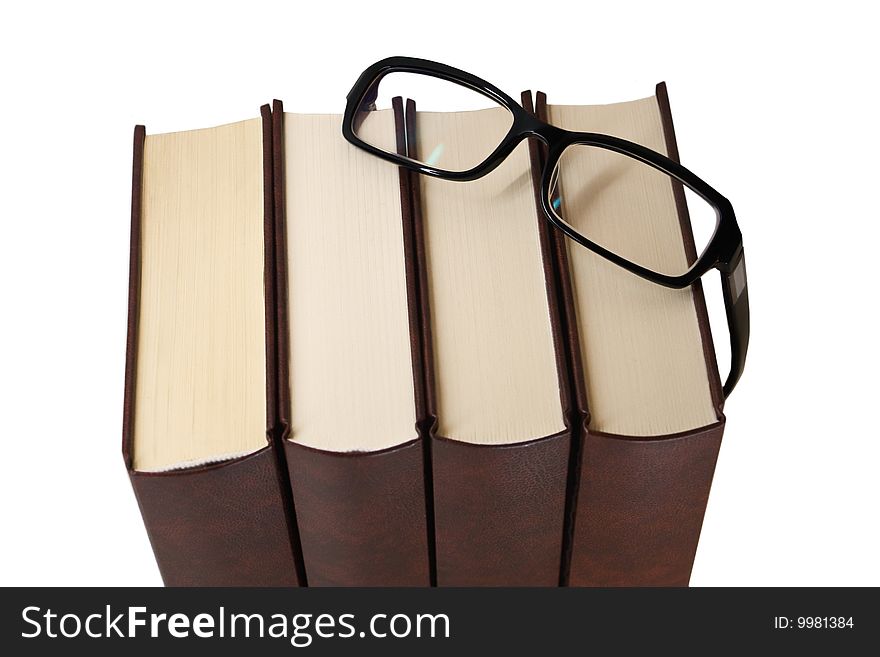 Pile of books with glasses on white background