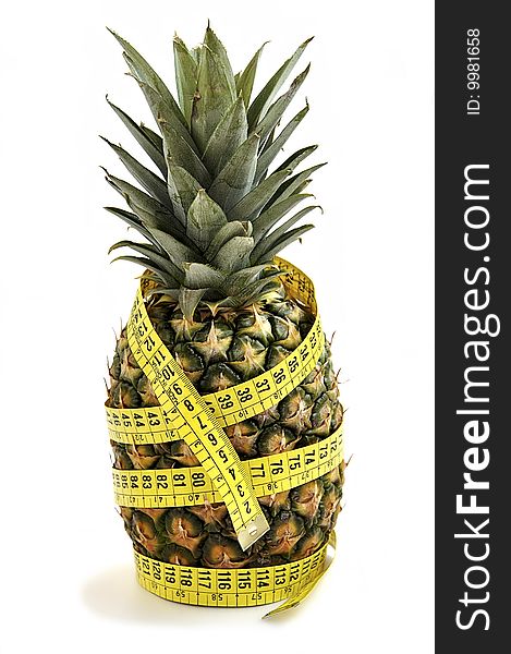 Pineapple with measuring tape isolated over white. Diet concept. Pineapple with measuring tape isolated over white. Diet concept.