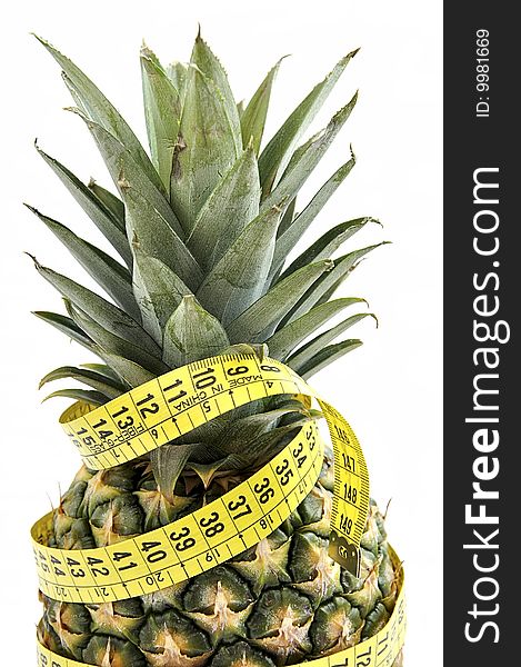 Pineapple with measuring tape isolated over white. Diet concept. Pineapple with measuring tape isolated over white. Diet concept.