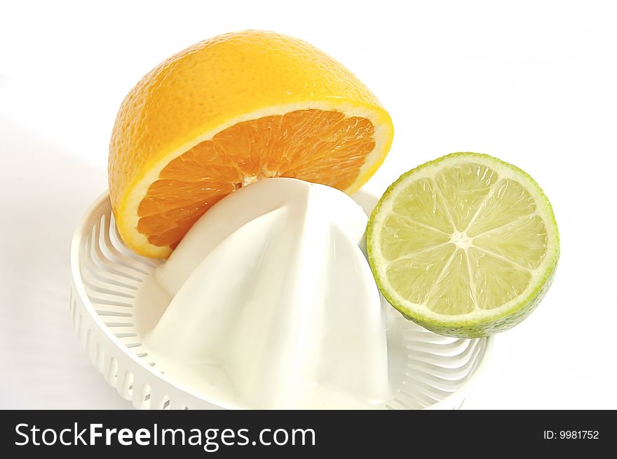 Juicer with slices of orange and lime isolated over white. Juicer with slices of orange and lime isolated over white.