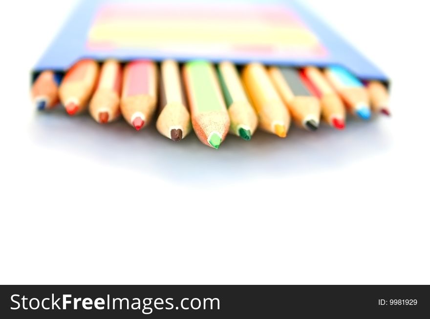 Colorful pencils in pencil-box on white background.