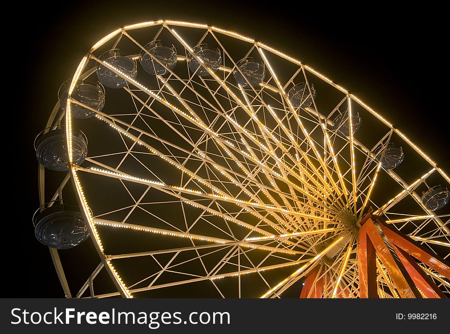 Side view of ferris wheel at night