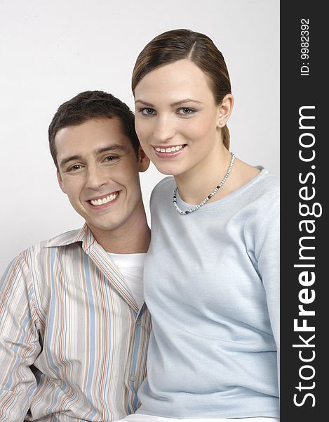 Funny woman and man sit together on a white background. Funny woman and man sit together on a white background