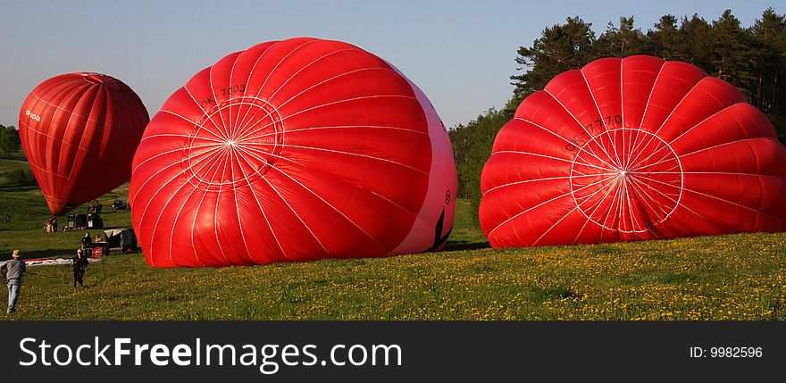 Three red hot air balloons