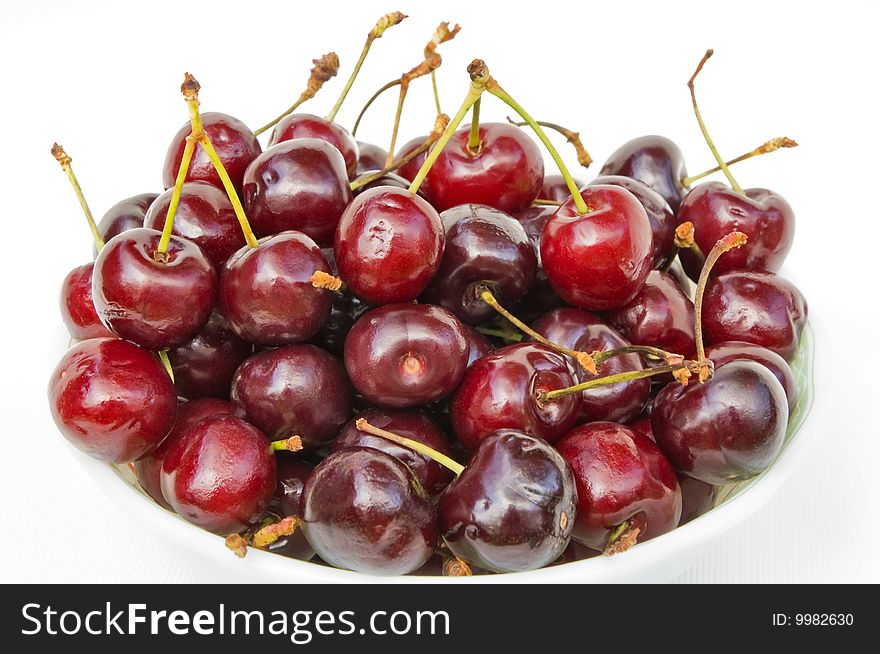 Large red juicy sweet cherry with shanks on a white background