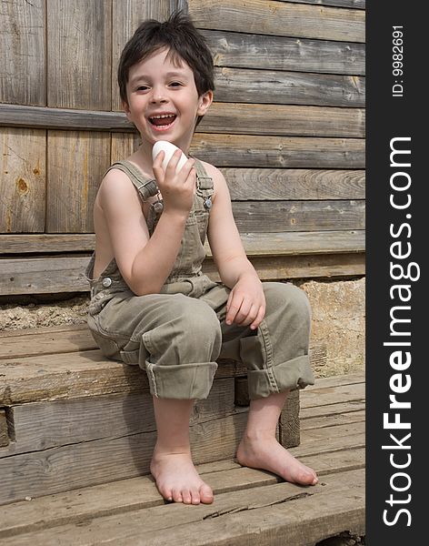 The boy with big goose egg on porch of house. The boy with big goose egg on porch of house