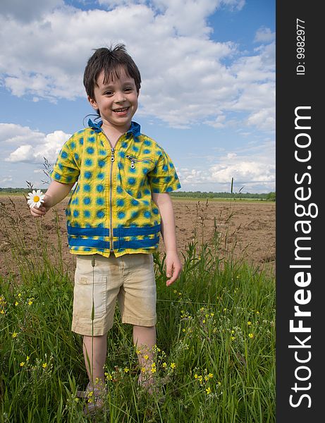 The boy with chamomille in the hand