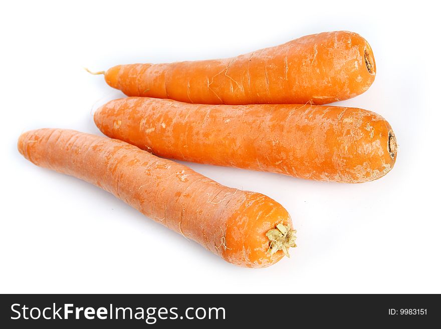 Three big  frash  carrots on the  table. Three big  frash  carrots on the  table