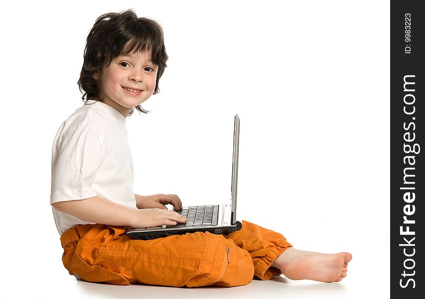 The merry  boy with laptop on white background. The merry  boy with laptop on white background