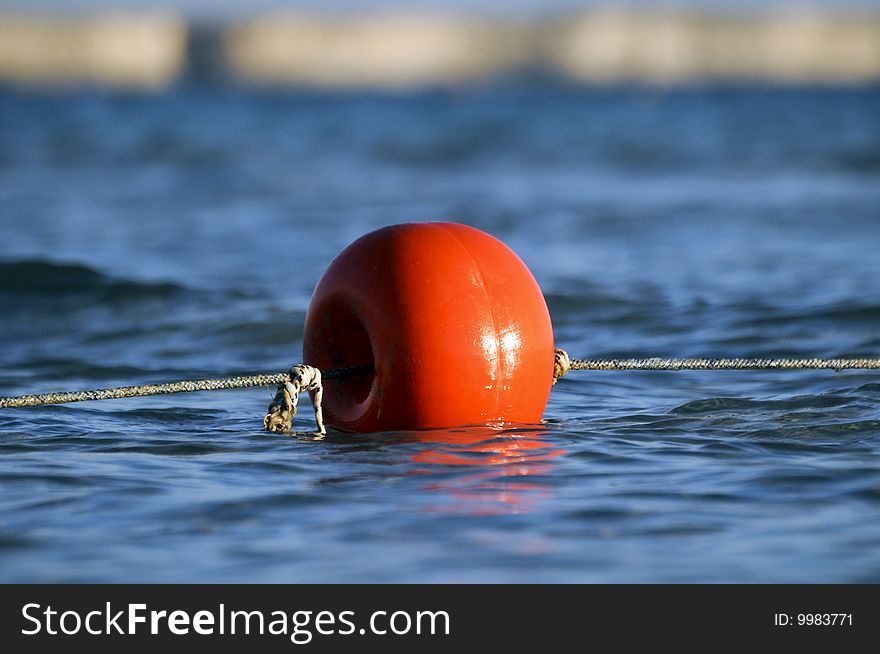 Red sea buoy on a blue sea