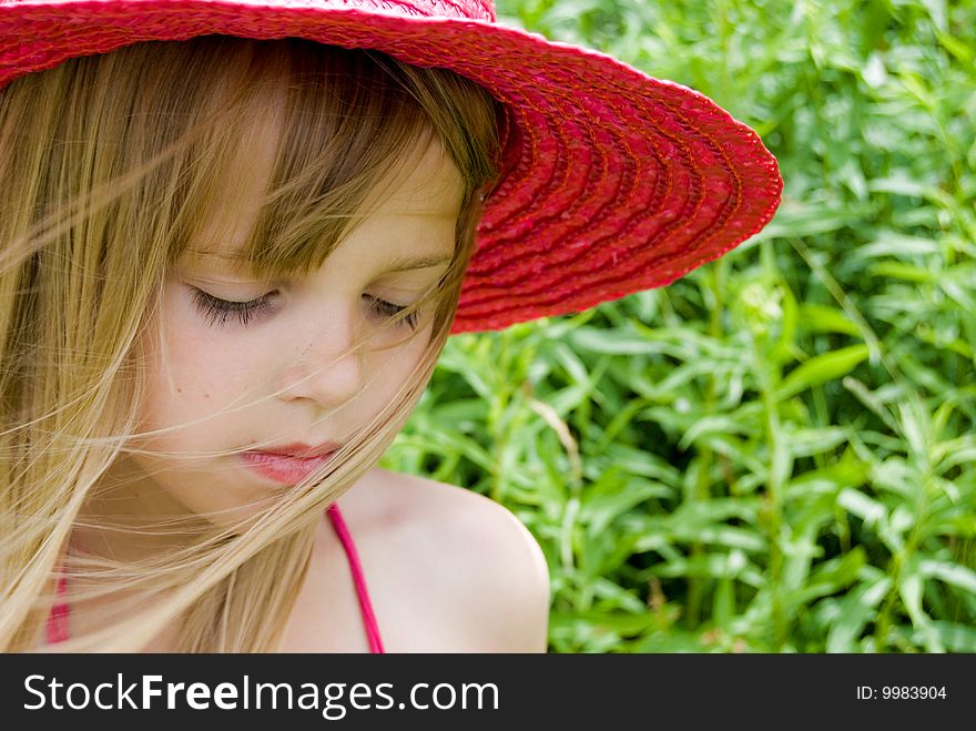 Little girl wearing a summer hat. Little girl wearing a summer hat.