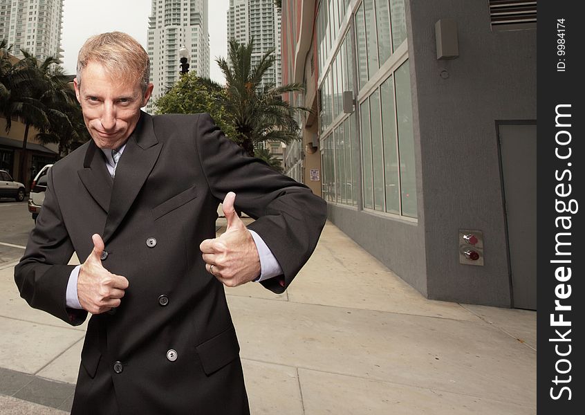 Mature businessman with thumbs up