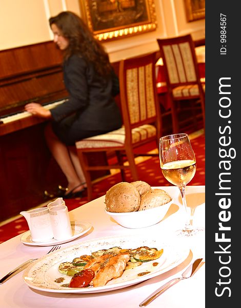 Woman in restorant playing piano. Woman in restorant playing piano