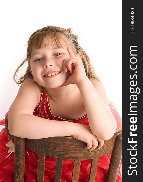 An image of nice child on a brown chair. An image of nice child on a brown chair