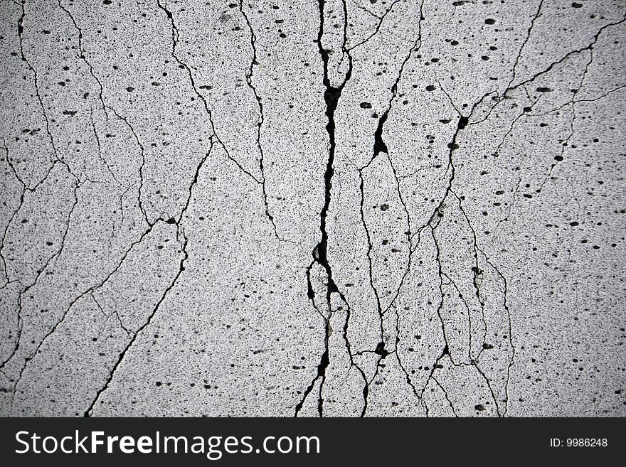 Close view of a textured wall with many cracks. Close view of a textured wall with many cracks.