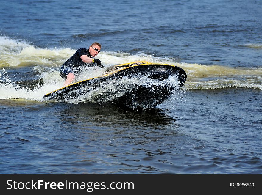 Young man riding jet ski