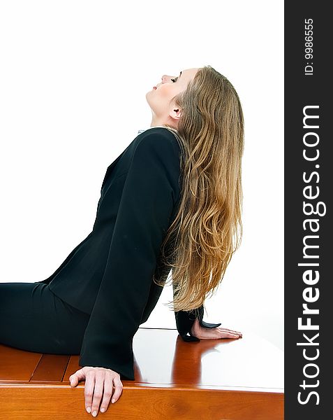 Young business lady sits on table with closed eyes. Young business lady sits on table with closed eyes