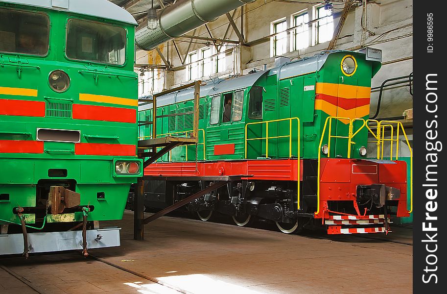 Two old locomotives in repair hangar are ready to use