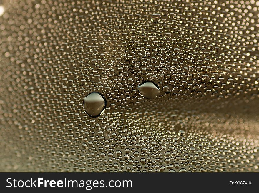 Closeup abstract of many condensated drops of water on a transparent surface. Closeup abstract of many condensated drops of water on a transparent surface.