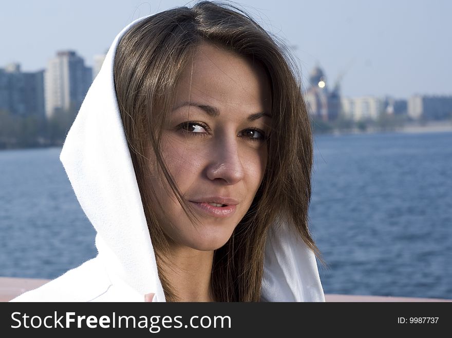 A young attractive girl goes for a walk near the river. A young attractive girl goes for a walk near the river