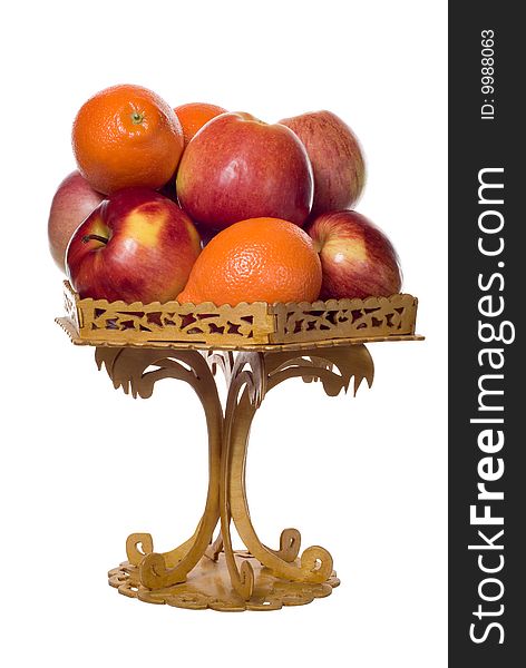 Apples and mandarins in the wood carved bowl on white background