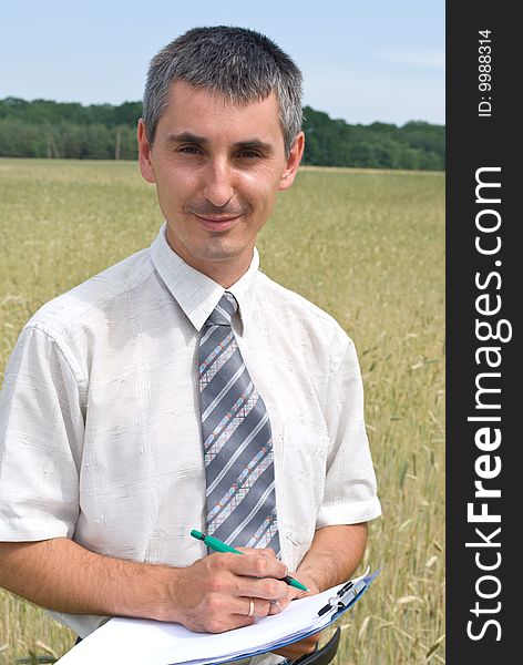 Man inspecting the wheat field