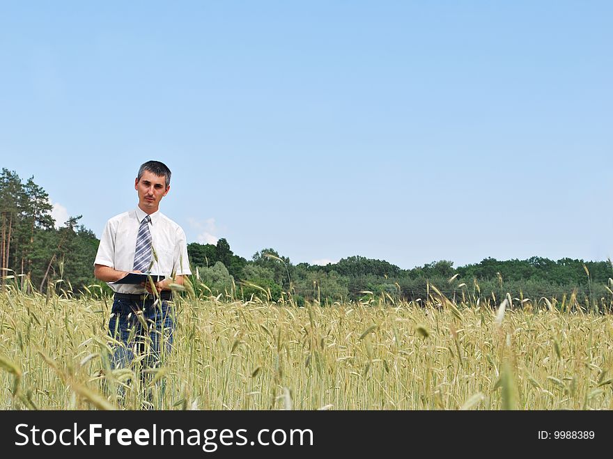 Man inspecting the wheat field