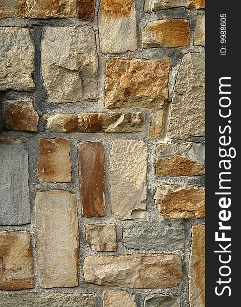 Photo texture of a stone brick wall with bricks in various nuances of beige. Photo texture of a stone brick wall with bricks in various nuances of beige