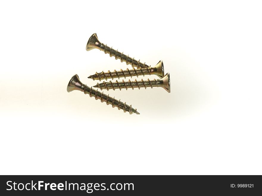 Some screws arranged on a white background, isolated.