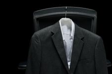 Business Jacket And White Shirt Hanging On A Chair Royalty Free Stock Images