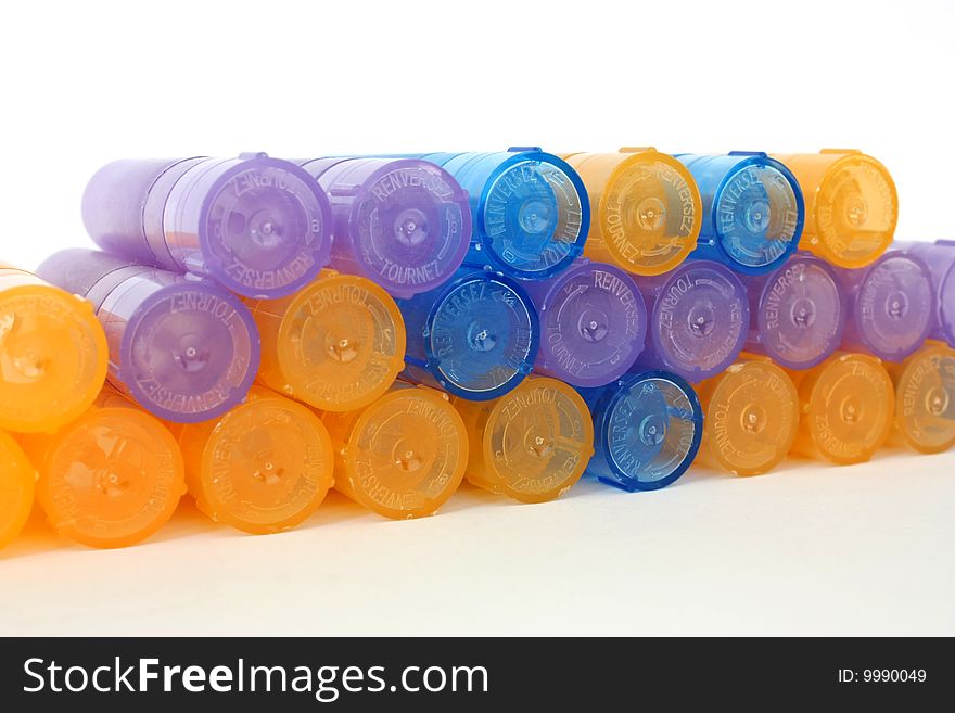 Row of colorful homeopathic containers isolated on the white background. Row of colorful homeopathic containers isolated on the white background.