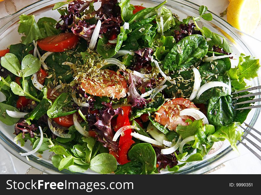 Table with typical portuguese salad with onions, tomatoes and pepper with orange juice and loaf of bread. Table with typical portuguese salad with onions, tomatoes and pepper with orange juice and loaf of bread.