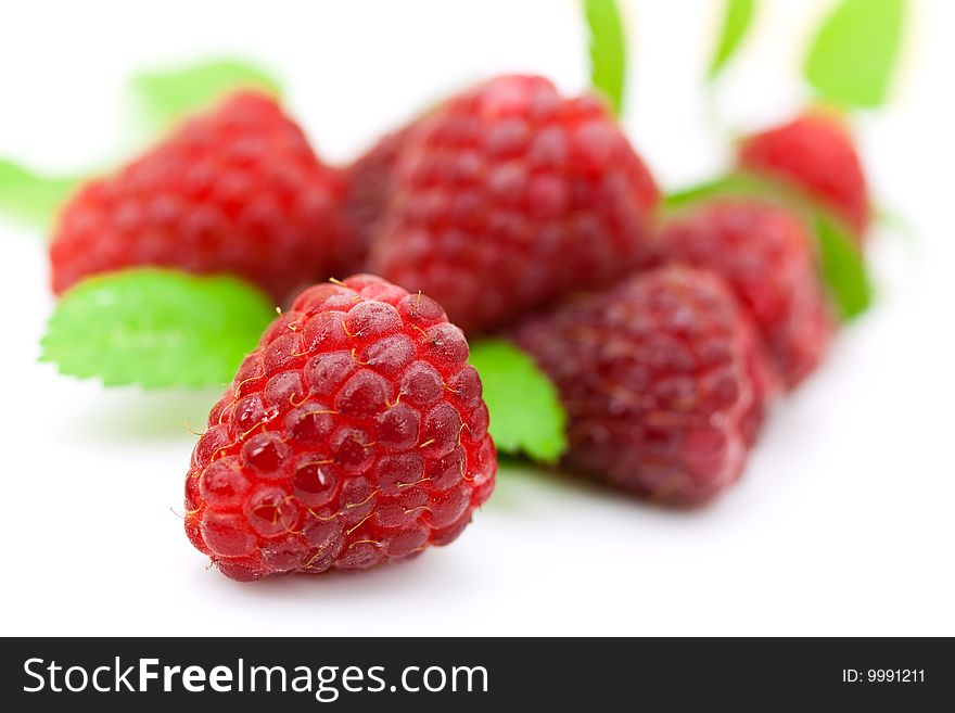 Ripe raspberry with mint leaves.