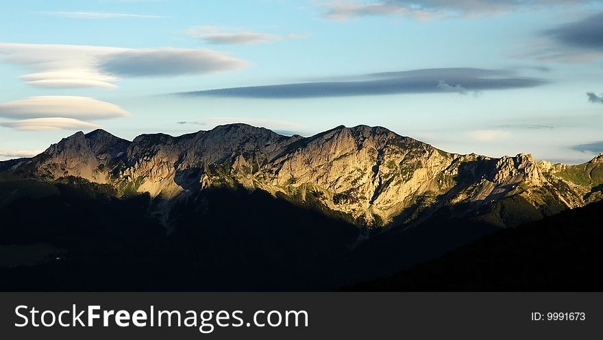 Nice clouds and mountains in evening sun. Nice clouds and mountains in evening sun.