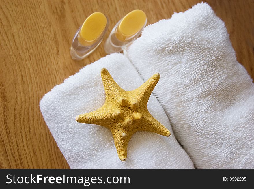 Body care and spa background with towels and shell