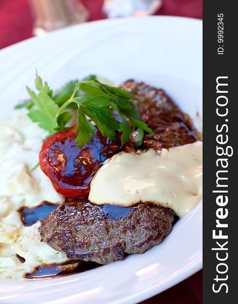 Sirloin strip Steak with vegetables and savory bechamel-sauce.