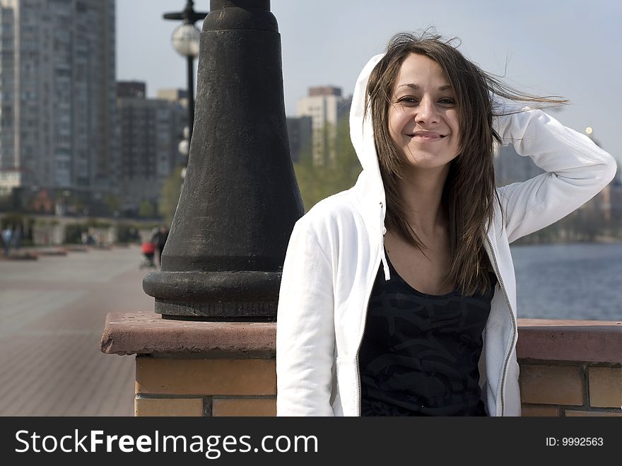 A girl laughing in a park, on a walk near the river. A girl laughing in a park, on a walk near the river