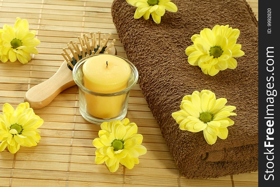 Spa background. Towel, yellow flowers and yellow candle. Spa background. Towel, yellow flowers and yellow candle.